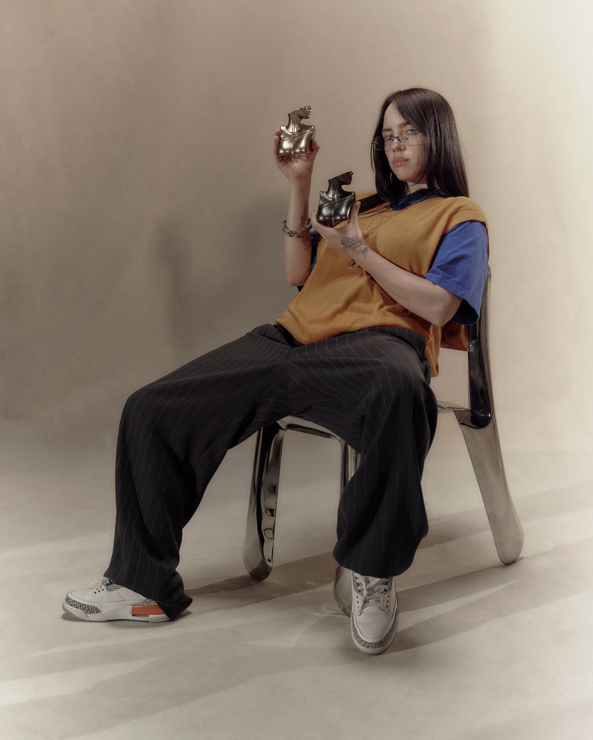 Billie Eilish holding Eilish Eau de Parfum bottles